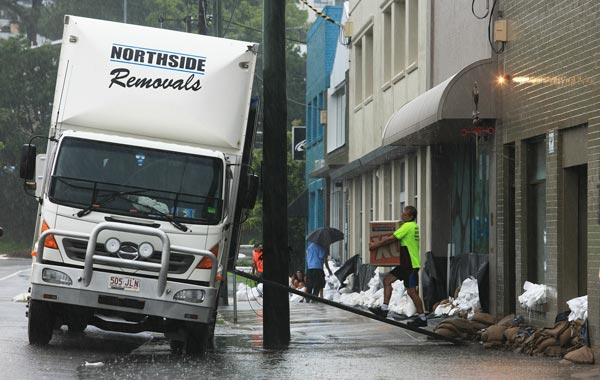 Business owners clear out their shops in preperation for high flood waters. (GETTY)