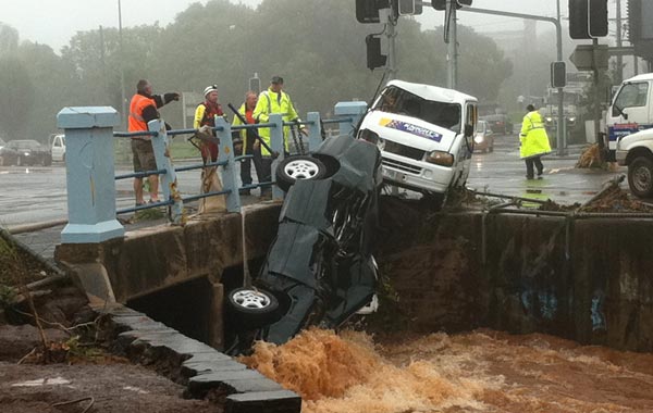 A flash flood sweeps cars against a bridge on a street in Toowoomba, about 105km (65 miles) west of Brisbane. (REUTERS)