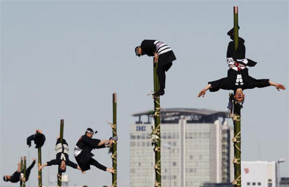 Members of the Edo Firemanship Preservation Association perform atop bamboo ladders during a New Year demonstration by the fire brigade in Tokyo. (REUTERS)