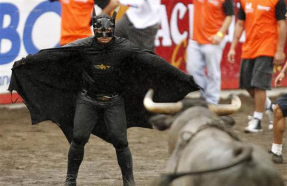 A man wearing a Batman costume gestures towards a bull in an improvised bullring during the annual bullfight festival in Zapote, near San Jose. More than 350 bullfighters participated in the traditional end of year bullfight. (REUTERS)