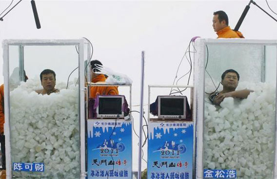 Chen Kecai (L) and Jin Songhao are seen in glass containers during a cold endurance competition on the Tianmen Mountain in Zhangjiajie, Hubei province, Chile. Chen and Jin competed by staying in a glass container filled with ice wearing only a pair of shorts. Jin won the competition with 120 minutes in the container, which outscored Chen's 118 minutes. Chen set the Guinness record for the longest time spent in direct full body contact with ice with 1 hour 48 minutes 21 seconds, local media reported. (REUTERS)