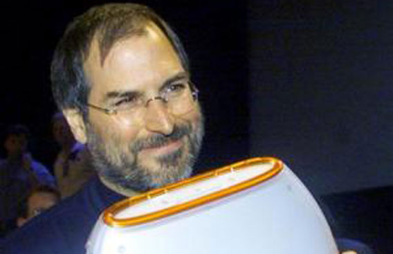 Apple Chief Executive Steve Jobs poses with the company's iBook portable computer at the MacWorld computer trade show in New York on July 21, 1999. (REUTERS)