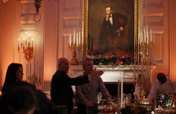 White House staff prepare the State Dining Room for the state dinner hosted by U.S. President Barack Obama for Chinese President Hu Jintao at the White House in Washington. A portrait of former US President Abraham Lincoln is shown above the fireplace. (REUTERS)