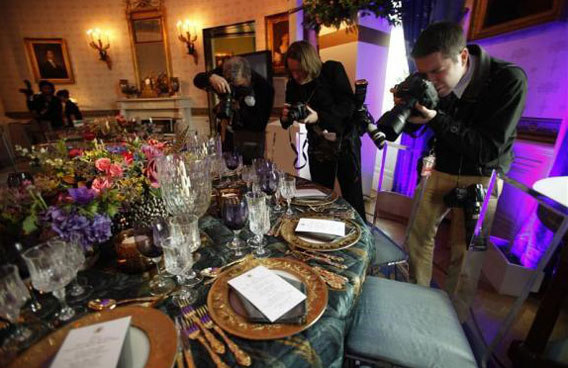 Photographers take pictures during a press preview of the table settings for the state dinner hosted by President Obama for Chinese President Hu Jintao at the White House. (REUTERS)