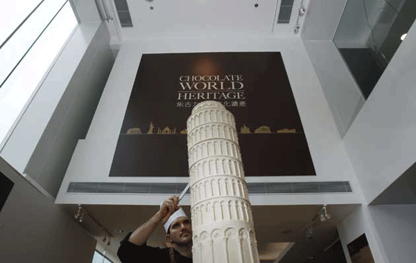 Italian chocolatier Mirco Della Vecchia puts the finishing touches on a chocolate sculpture of the Torre pendente di Pisa as part of his 'Chocolate World Heritage' exhibition in Hong Kong. (REUTERS)