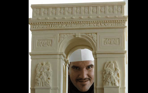 Italian chocolatier Mirco Della Vecchia poses with a chocolate sculpture of the Arc de Triomphe, as part of his 'Chocolate World Heritage' exhibition in Hong Kong. (REUTERS)