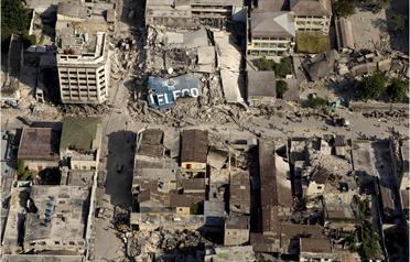 In this handout image provided by the United Nations, the downtown core shows the damage after an earthquake measuring 7.0 rocked the Haitian capital just before 5 pm on Wednesday in Port-au-Prince, Haiti. Much of Port-au-Prince was reduced to rubble by the quake on January 12, but the airport was operational, opening the way for international relief aid to be ferried in by air as well as by sea. (GETTY IMAGES)