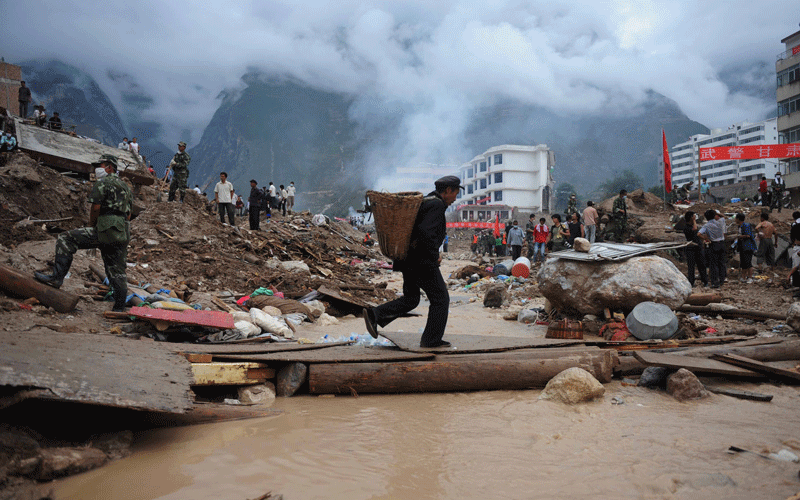 Rescuers and residents search the rubble after a massive landslide in Zhouqu, northwest China's Gansu province. (AFP)