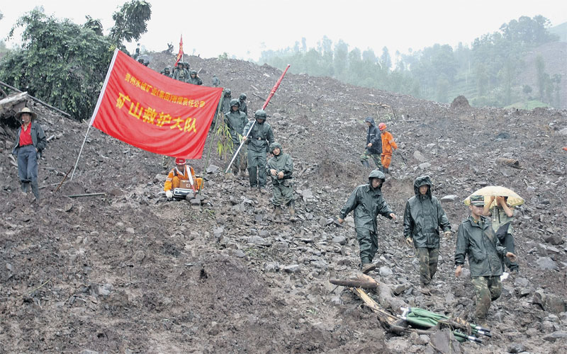 Rescuers search for victims after a rain-triggered landslide struck Dazhai village yesterday. Hope of finding survivors was diminishing as rescuers used heavy machinery to search for over a hundred people trapped. (AP)