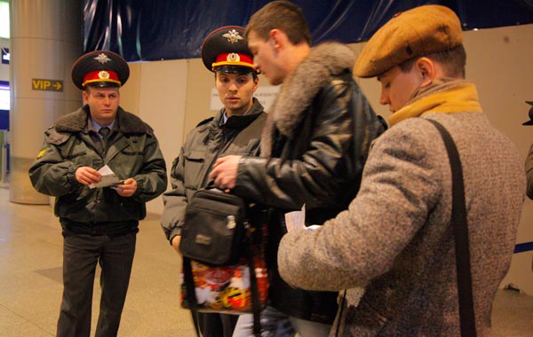 Police officers check ID documents inside Moscow's Domodedovo international airpor. (AP)