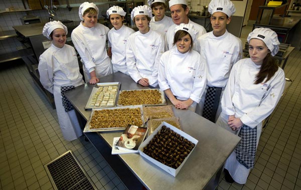 Students pose with their teacher Henk van Gurp (4th R) behind a selection of insect snacks at the Rijn IJssel school for chefs in Wageningen January 12, 2011. All you need to do to save the rainforest, improve your diet, better your health, cut global carbon emissions and slash your food budget is eat bugs. Chef Henk van Gurp, who created recipes for mealworm quiche and chocolate pralines with buffalo worms, sees no reason to disguise the ingredients, and sprinkles mealworms on top of the quiche filling and onto the chocolate buffalo worms as protein. (REUTERS)