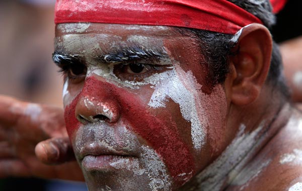 An Aboriginal man performs part of the Woggan-ma-gule ceremony with their contemporary interpretation of a creation story from the Yuin people during Australia Day celebrations in Sydney. (AP)