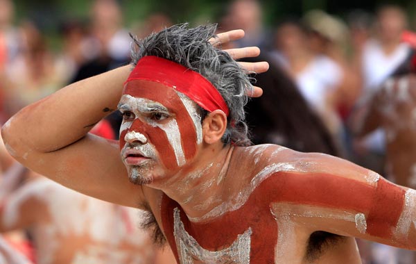 A young Aboriginal man portrays a shark as he performs part of the Woggan-ma-gule ceremony with their contemporary interpretation of a creation story from the Yuin people during Australia Day celebrations in Sydney. (AP)