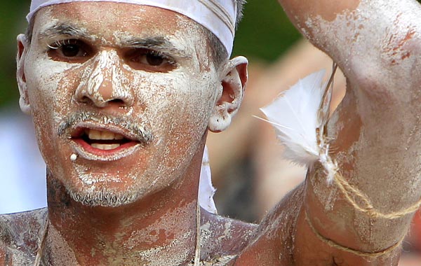 Darren Compton performs with other Aboriginal men and women part of the Woggan-ma-gule ceremony with their contemporary interpretation of a creation story from the Yuin people during Australia Day celebrations in Sydney. (AP)