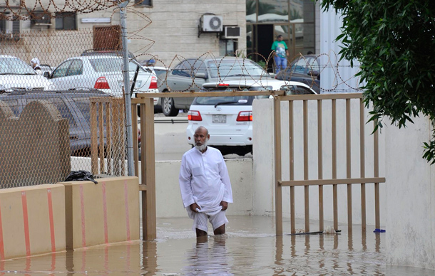 A man walks on a flooded street after heavy rainfall in Jeddah. Torrential rainfall submerged streets and cut off electricity in parts of Saudi Arabia's second largest city Jeddah on Wednesday, raising fears of a repeat of floods in 2009 which killed more than 120 people. (REUTERS)