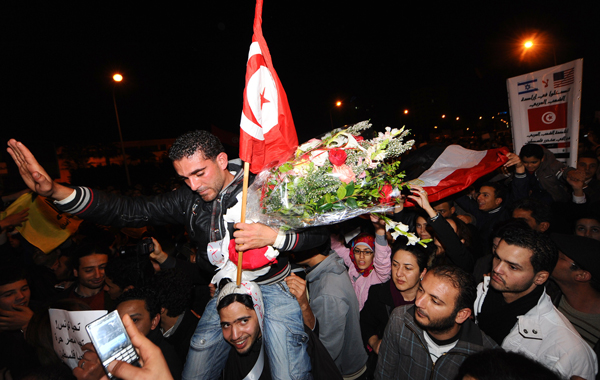 Tunisians celebrate in front of the Egyptian embassy in Tunis after Egypt's President Hosni Mubarak ceded power to a junta of senior military commanders. (AFP)