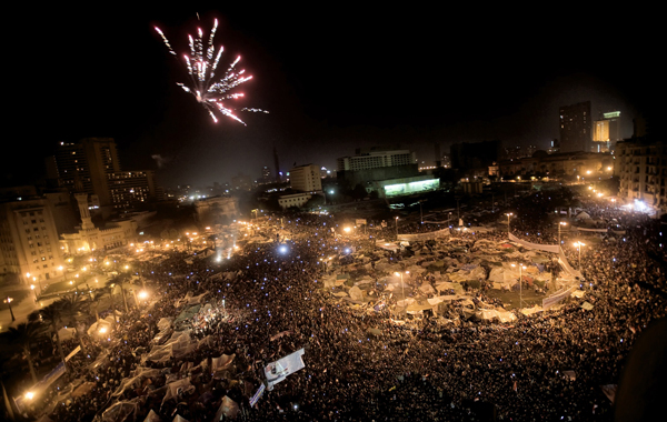 Egyptian anti-government protesters celebrate under fireworks at Cairo's Tahrir Square after president Hosni Mubarak stepped down. (AFP)