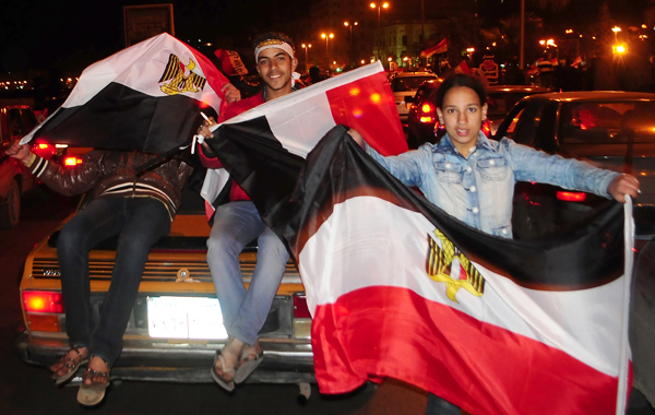 Egyptian anti-government protesters celebrate in the coastal city of Alexandria on February 11, 2011 after president Hosni Mubarak stepped down and handed power to the military. (AFP)