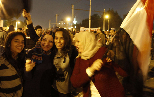 Egyptian anti-government protesters celebrate outside the presidential palace in Cairo after President Hosni Mubarak stepped down. (AFP)