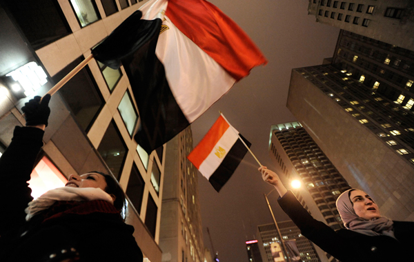 Wasila Diab right, of Rockford, Ill., and Sara Anwar of Cairo, Egypt celebrate outside the Egyptian Consulate in downtown Chicago. (AP)