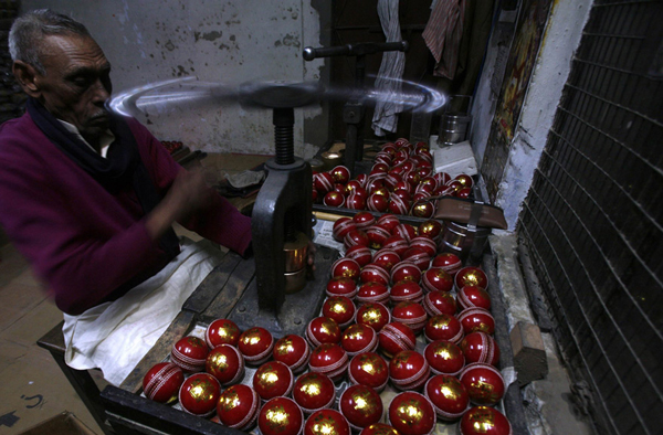 A worker stamps balls before they are packed at a factory in Meerut, 80 km (50 miles) northeast of Delhi. (REUTERS)