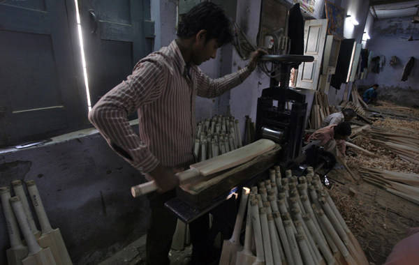 A worker files the edges of a cricket bat to a smooth finish at a factory in Meerut, 80 km (50 miles) northeast of Delhi. (REUTERS)