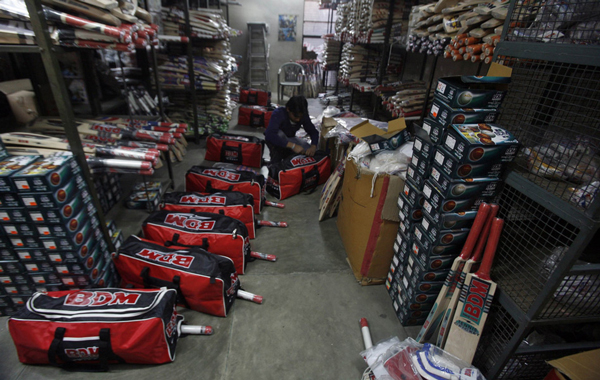 A worker packs cricket bats before they are dispatched for sale at a factory in Meerut, 80 km (50 miles) northeast of Delhi. (REUTERS)