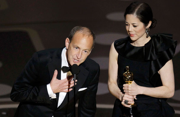 Charles Ferguson (L) and Audrey Marrs accept the Oscar for best documentary feature for "Inside Job" during the 83rd Academy Awards in Hollywood, California. (REUTERS)