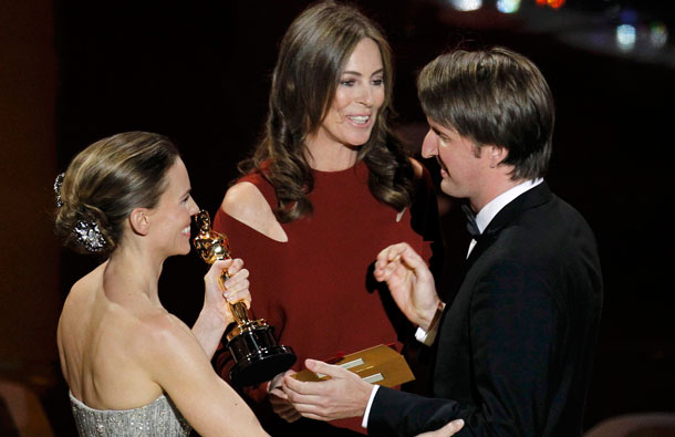 British director Tom Hooper (R) accepts the Oscar for best director for his film "The King's Speech" from director Kathryn Bigelow (C) and actress Hilary Swank during the 83rd Academy Awards in Hollywood, California. (REUTERS)