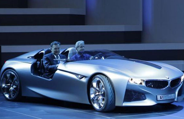 BMW's Chief executive officer Norbert Reithofer (L) arrives on stage in a BMW Vision Connected Drive concept car during the first media day of the 81st Geneva Car Show at the Palexpo in Geneva March 1, 2011. (REUTERS)