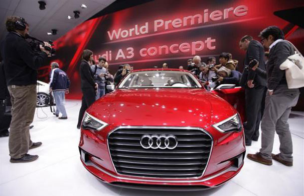 Journalists surround a new A3 Concept car, displayed on the exhibition stand of Audi, during the first media day of the 81st Geneva International Motor Show at the Palexpo in Geneva March 1, 2011. (REUTERS)