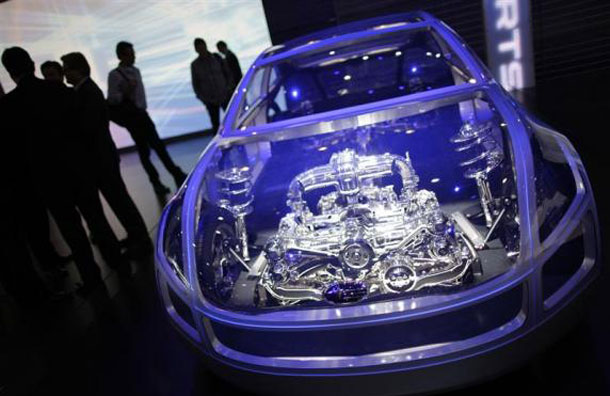 Visitors and Media walk past a Subaru concept car displayed during the first media day of the 81st Geneva International Motor Show at the Palexpo in Geneva March 1, 2011. (REUTERS)