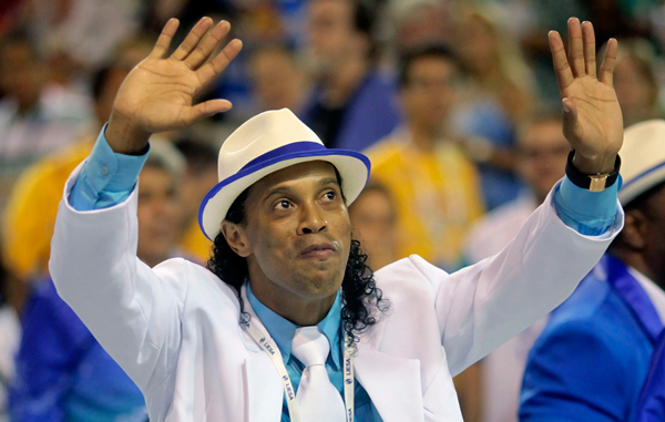 Brazilian soccer player Ronaldinho dances with members of the Portela samba school during the annual Carnival parade in Rio de Janeiro's Sambadrome. (REUTERS)