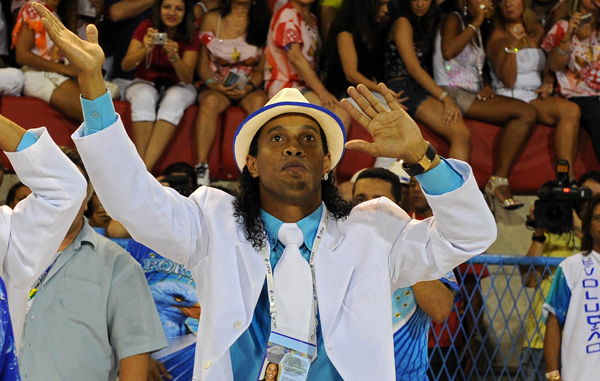 Brazilian football player Ronaldinho, member of Portela samba school, performs during the first night of carnival parades at the Sambadrome, in Rio de Janeiro, Brazil. (AFP)