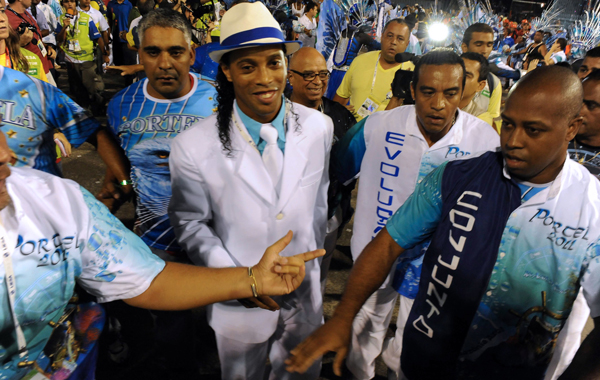 Brazilian football player Ronaldinho (C), member of Portela samba school, performs during the first night of carnival parades at the Sambadrome, in Rio de Janeiro, Brazil. (AFP)