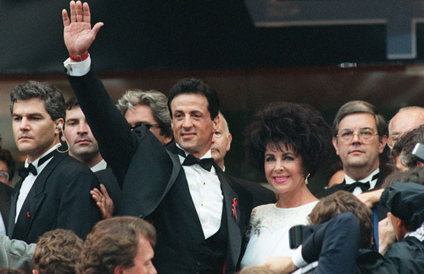 Actors Elizabeth Taylor (R) and Sylvester Stallone (L) greet the crowd 20 May 1993 before the showing of the latest Stallone action film "Cliffhanger" during the Cannes Film Festival. Legendary Hollywood actress and violet-eyed beauty Elizabeth Taylor, who captured hearts in "National Velvet" to launch a film career that spanned five decades, has died March 23, 2011 at the age of 79. (AFP)