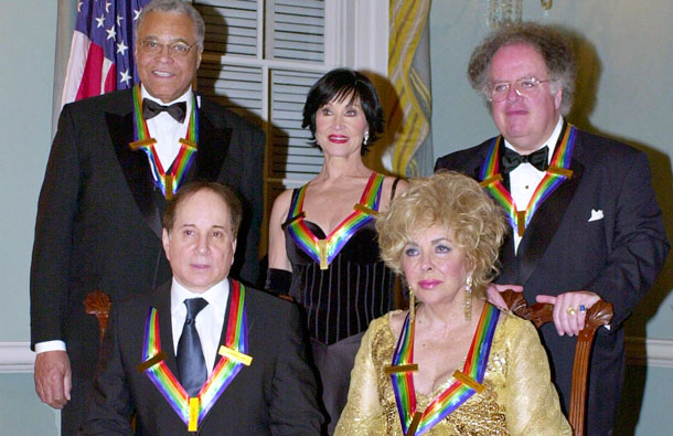 Actress Elizabeth Taylor (front R), singer Paul Simon (front L), actor James Earl Jones (rear L), theater actress Chita Rivera (C) and conductor James Levine pose for the "family" photo of the 2002 Kennedy Center Honorees, in this file image from December 7, 2002. This year's winners were honored for their lifetime contributions to American culture through the performing arts. Hollywood legend Taylor, one of the most alluring actresses of the 20th century, has died at the age of 79 at Cedar Sinai Hospital in Los Angeles ABC News reported on March 23, 2011. (REUTERS)