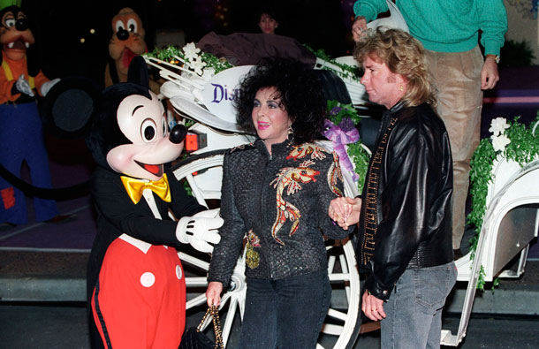 Actress Elizabeth Taylor and her husband Larry Fortensky are greeted by Mickey Mouse as Taylor celebrates her 60th birthday at Disneyland in Anaheim,Calfornia in this February 27, 1992 file photograph.  Taylor died surrounded by her four children on March 23 at age 79, her publicist said. She died at Cedars-Sinai Hospital in Los Angeles surrounded by her four children after having been hospitalized six weeks ago with congestive heart failure, a statement from publicist Sally Morrison said. (REUTERS)