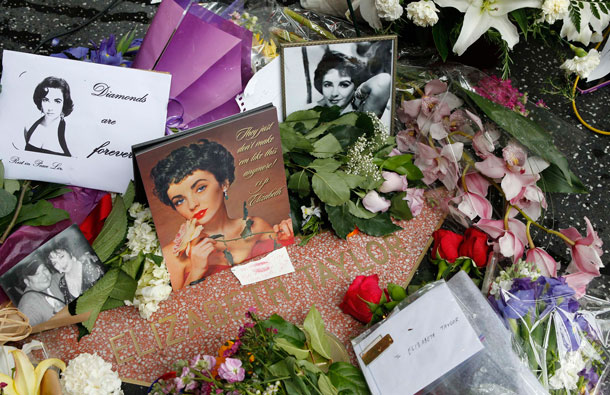 Flowers, photographs and notes from fans adorn the Hollywood Walk of Fame star of actress Elizabeth Taylor in Hollywood, California, March 23, 2011. Taylor died on March 23, 2011 at age 79 at Cedars-Sinai Hospital in Los Angeles surrounded by her four children after having been hospitalized six weeks ago with congestive heart failure, a statement from publicist Sally Morrison said. (REUTERS)