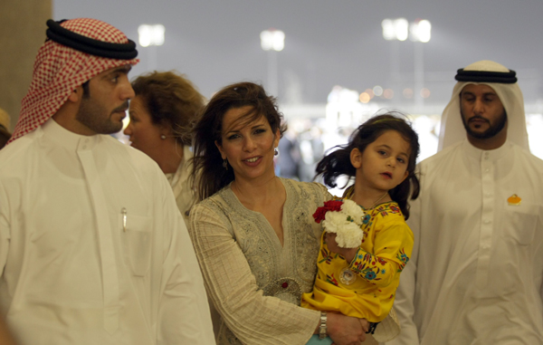 Princess Haya bint al-Hussein , wife of Vice President and Prime Minister of the UAE and Dubai's ruler, His Highness Sheikh Mohammed bin Rashid Al Maktoum, carries her daughter Al-Jalila Bint Mohammed nin Rashid Al Maktoum as she attends the Dubai World Cup 2011 at Meydan race track in the rich Gulf Emirate. (REUTERS)