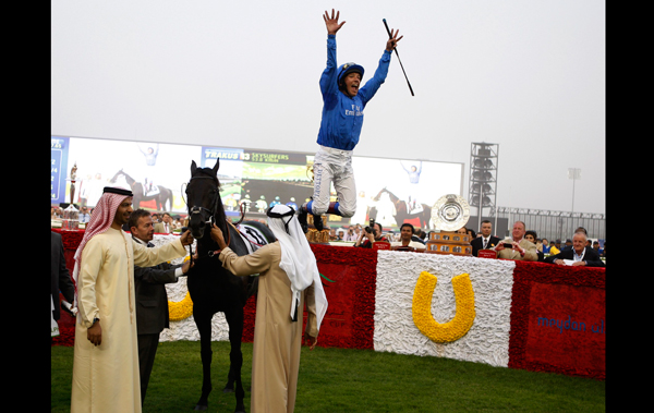 Lanfranco Dettori riding Skysurfers celebrates after winning the third race of the 16th Dubai World Cup at the Meydan in Dubai. (REUTERS)