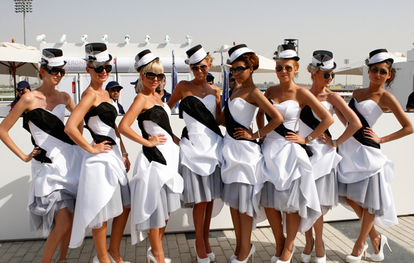 Women pose for a picture ahead of the 16th Dubai World Cup at the Meydan Racecourse in Dubai. The Dubai World Cup, with a cash prize of $10 million, is horse racing's richest race. (REUTERS)