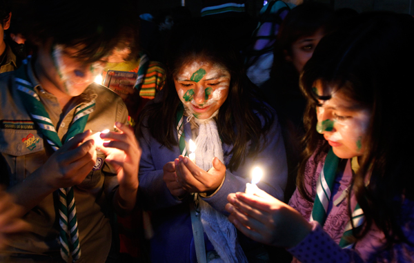 Children attend a a candlelight vigil marking “Earth Hour” at the plaza del Bicentenario in La Paz, Bolivia. (AP)