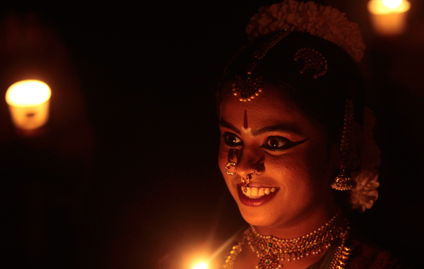 A girl, dressed in traditional outfit, holds a candle during a vigil to mark Earth Hour in Mumbai, India, Saturday. Earth Hour takes place worldwide at 8.30pm local time and is a global call to turn off lights for 60 minutes in a bid to highlight the global climate change. (AP)