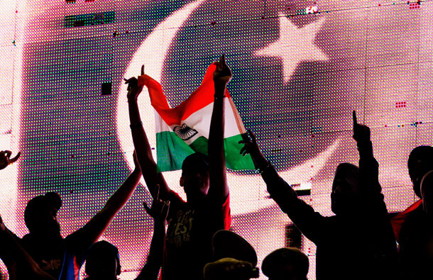 Cricket fans hold an Indian flag as the flag of Pakistan is displayed on an electronic scoreboard during the 2011 ICC World Cup second Semi-Final between India and Pakistan at Punjab Cricket Association (PCA) Stadium on March 30, 2011 in Mohali, India. (GETTY/GALLO)