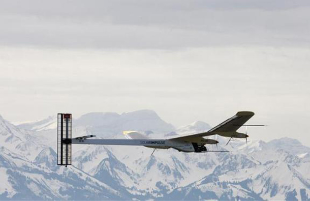 German test pilot Markus Scherdel, steers the solar-powered Solar Impulse HB-SIA prototype airplane during his first flight in front of the Swiss Alps. (REUTERS)