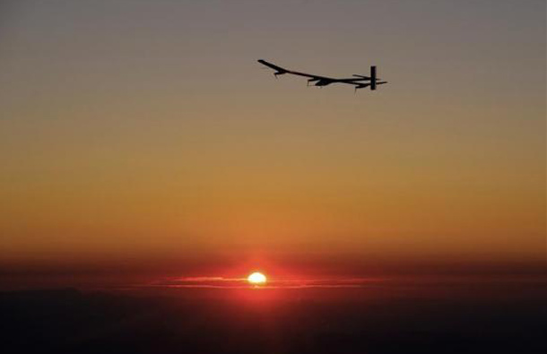 Solar Impulse's Chief Executive Officer and pilot Andre Borschberg flies the solar-powered HB-SIA prototype airplane at sunrise during the plane's first night flight attempt near Payerne airport. (REUTERS)