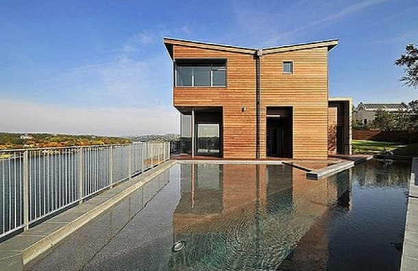 For Sale: $3,150,000: This ultra-contemporary home seemingly perches on a platform above Lake Austin and features 180-degree views of the lake and Mount Bonnell. The floor-to-ceiling low-emissivity windows (commonly called "low e") reduce the total heat flow through the glass, thus better controlling the home's climate. The 5-bedroom, 5.5-bath home was constructed entirely from plantation-grown trees and includes a full kitchen, dining room, living room and custom 83-foot lap pool. The standing metal butterfly roof collects rainwater and stores it in a 5,000-gallon tank beneath the house. Austin real estate is currently a hot commodity with home values registering at $235,000. (AGENCY)