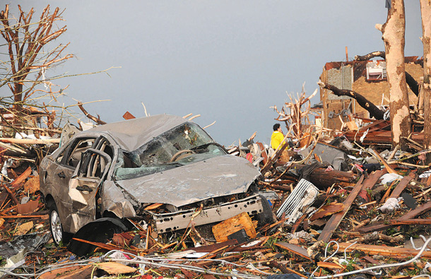 Vehicles and houses in the vicinity of Twenty-fourth and Main Streets are a jumble of rubble after a the tornado swept through Joplin, Mo., on Sunday evening. (AP)