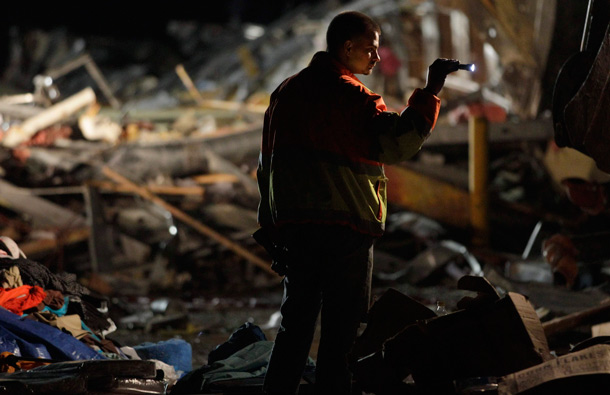 An emergency worker searches a Walmart store that was severely damaged by a tornado in Joplin, Mo., Sunday. A large tornado moved through much of the city, damaging a hospital and hundreds of homes and businesses. (AP)